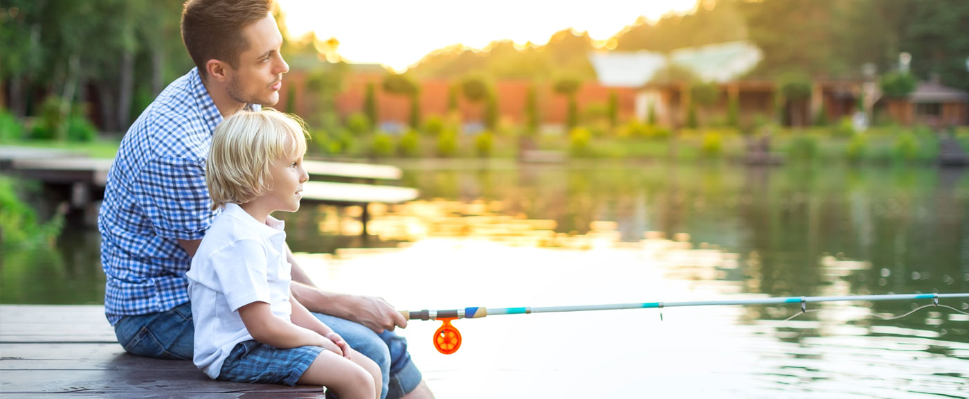 A father and sun fishing from a pier at sunset A father and sun fishing from a pier at sunset.